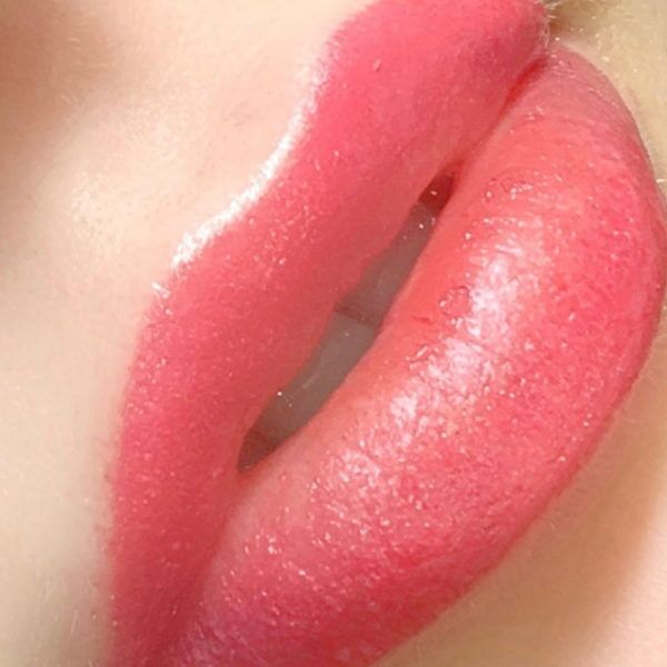 A close up of a woman's pink lips.